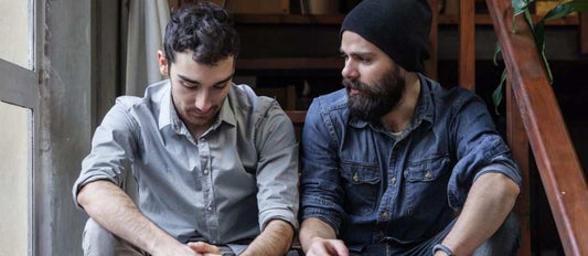 Two men with beards discussing mental health struggles