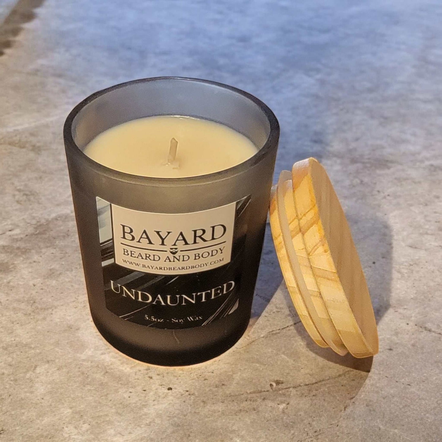 undaunted soy wax candle on concrete counter